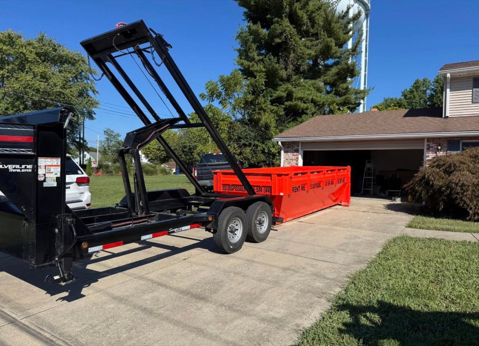 BS Disposals dump trailer being placed in a driveway in Moores Hill, Indiana